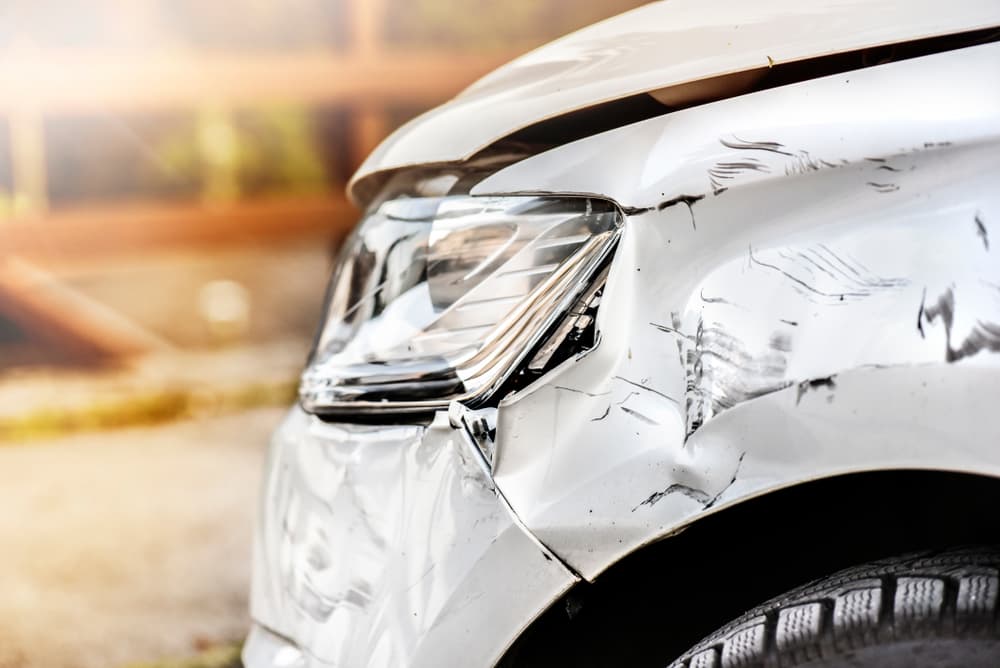 Car crash of front bumper white car.