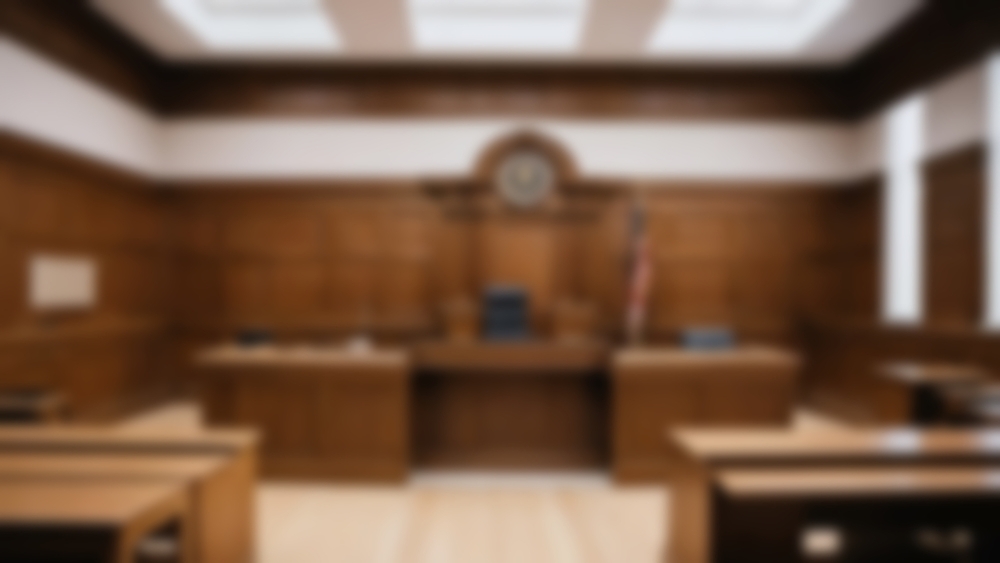 Intentionally out-of-focus image of the interior of a courtroom between trials