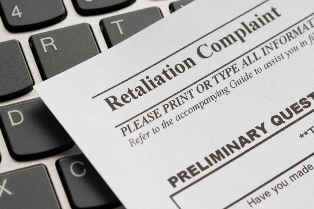 Retaliation complaint form on top of work laptop keyboard
