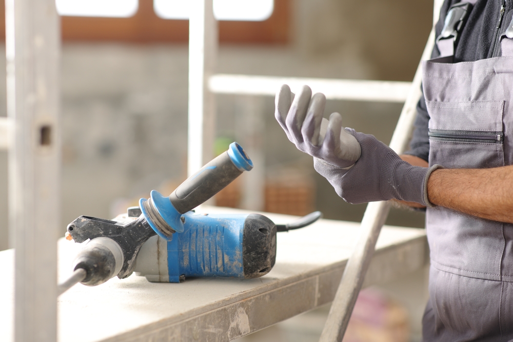 Construction worker experiencing pain from repetitive motion injury